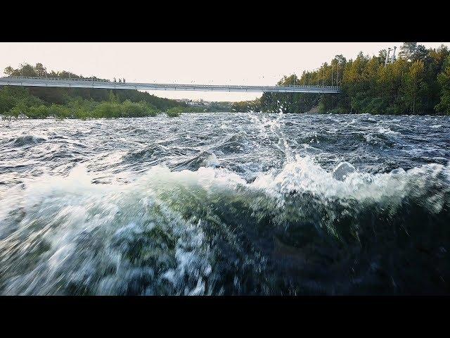 a risky flight on a drone over the water at an extremely low altitude above a stormy river