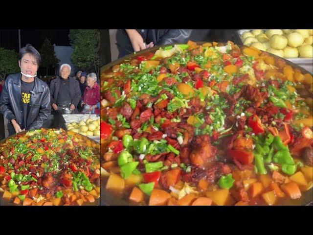 A Chinese Guy Cook Pork Meat Potato Noodles Rice Food for the old on the Street in a Village