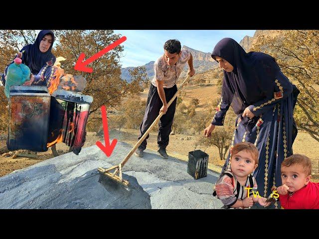 Nargis and the Twins: Spraying tar on the roof of the cottage to protect it from the rain! ️