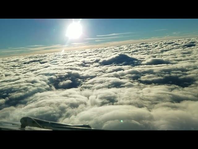 Airliner Decending Through Clouds