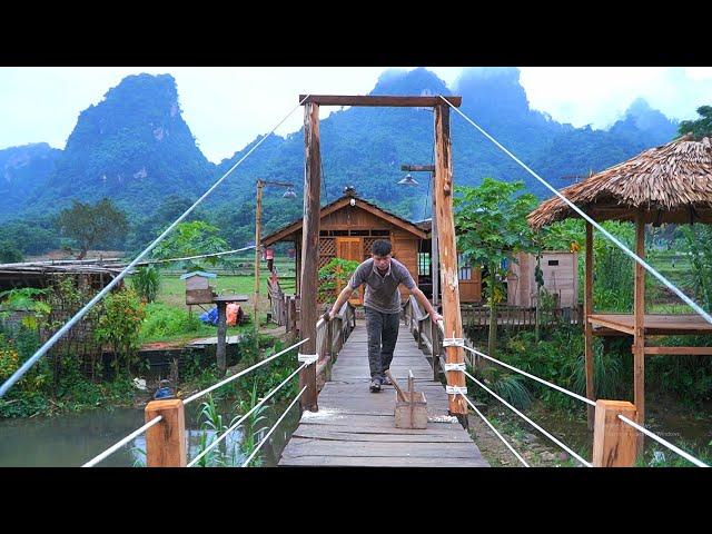 Completing the safety railing of the suspension bridge. Together Enjoy banh cuon on a rainy day