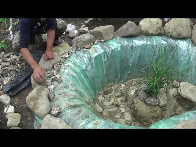 Waterfall and pond with fish in the garden (first part)