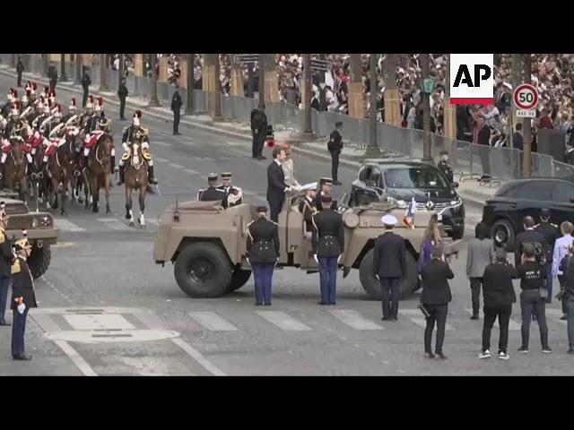 Macron arrives at Bastille Day parade, greets Modi