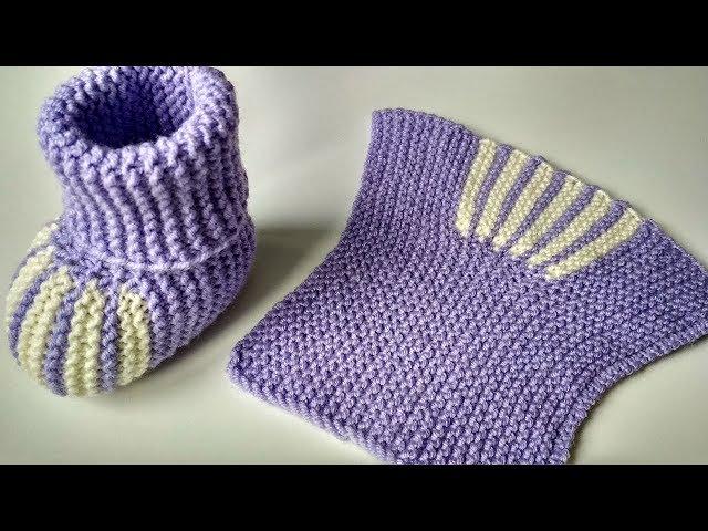 Knitted booties. Simple baby socks with knitting needles for newborns