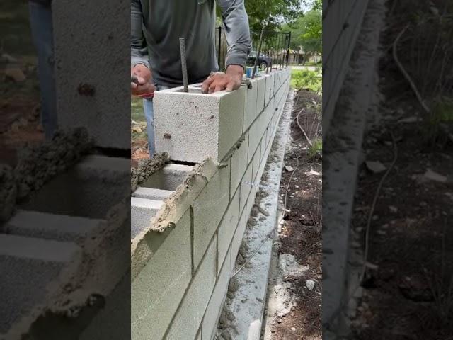 Installing some 8x8x16 CMU blocks for a decretive fence wall