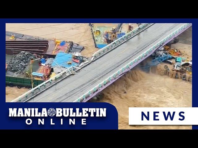 Raging floodwaters swept away barges and damaged a bridge on Marikina River