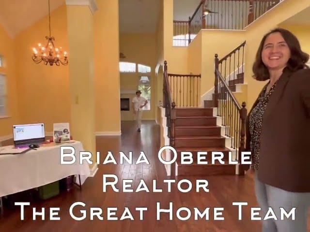 Brianna & David Oberle, The Great Home Team, show the welcoming arches of 4907 Jamestown Lane.