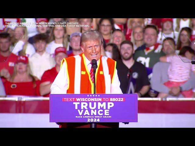 Trump talks about lack of certainty getting into garbage truck, wearing vest at Green Bay rally