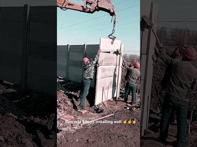 Precast concrete panels installing wall with useful excavator