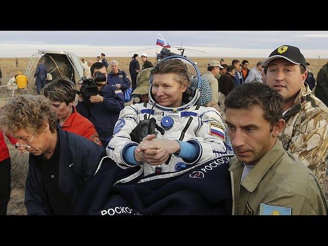 Record-breaking Russian cosmonaut returns to Earth