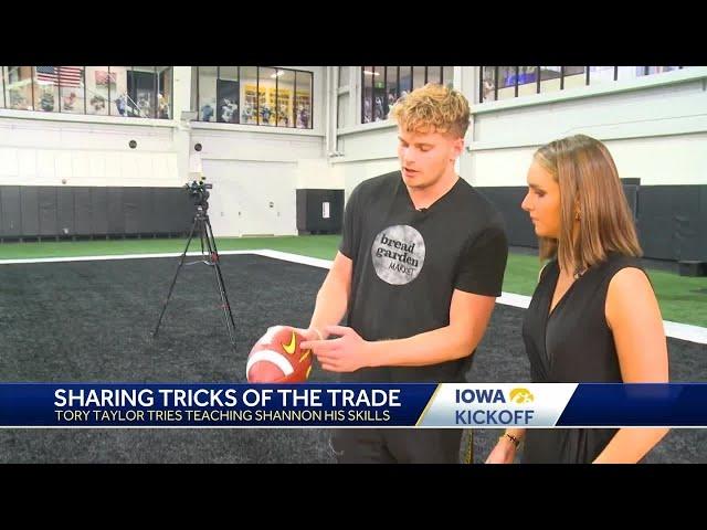 Tory Taylor teaches KCCI's Shannon Ehrhardt how to punt