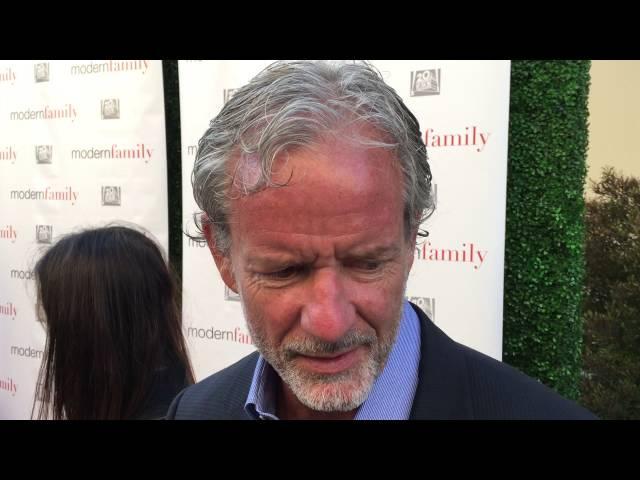 Co-creator Christopher Lloyd chats on the "Modern Family" red carpet for an Emmy voter FYC screening