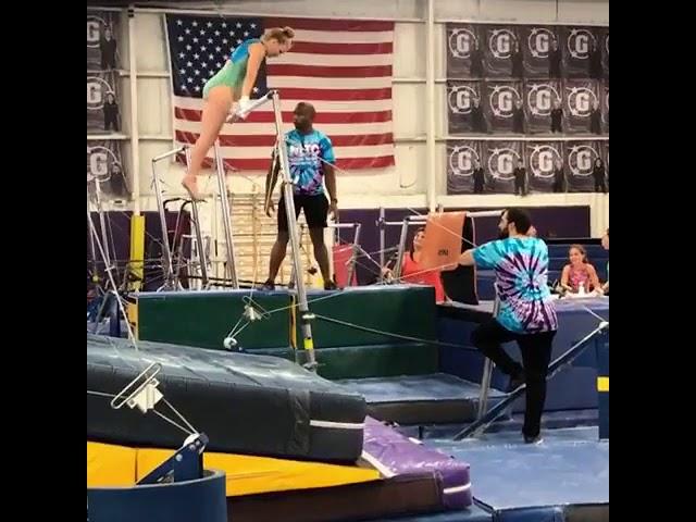 Gymnastics Coach Rolls Over Uneven Bars and Falls While Helping a Girl - 1064389