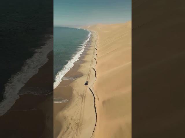 Drive along the beach where the ocean meets the Namib Desert in Namibia 