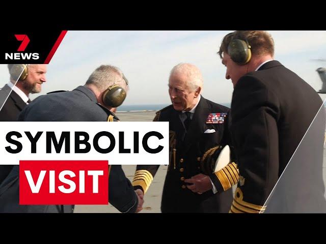 King Charles makes a rare flying visit to troops on an aircraft carrier | 7NEWS