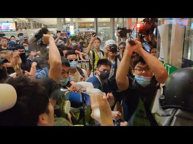 Hong Kong policeman draws pistol on protesters after being beaten with own baton