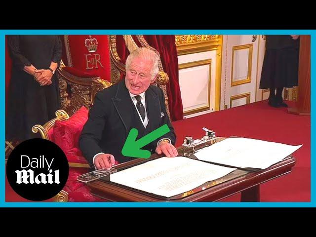 Moment King Charles III furiously motions for aide to move ink pot as he signs proclamation