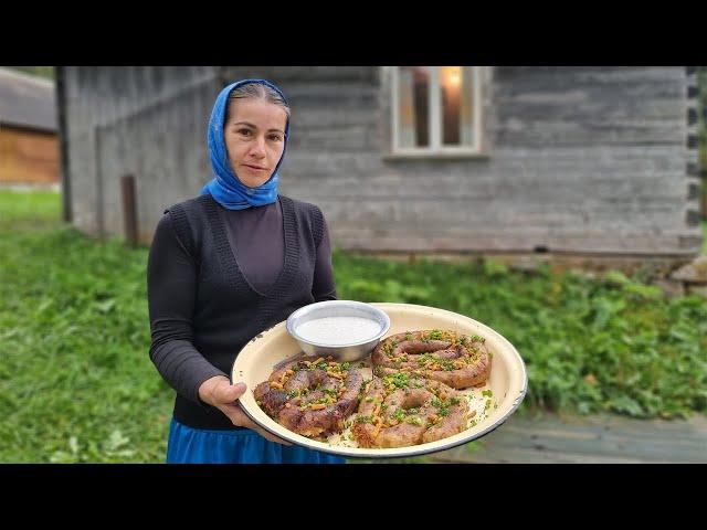 THE WOMAN LIVES ALONE IN THE MOUNTAINS. COOKING POTATO SAUSAGES