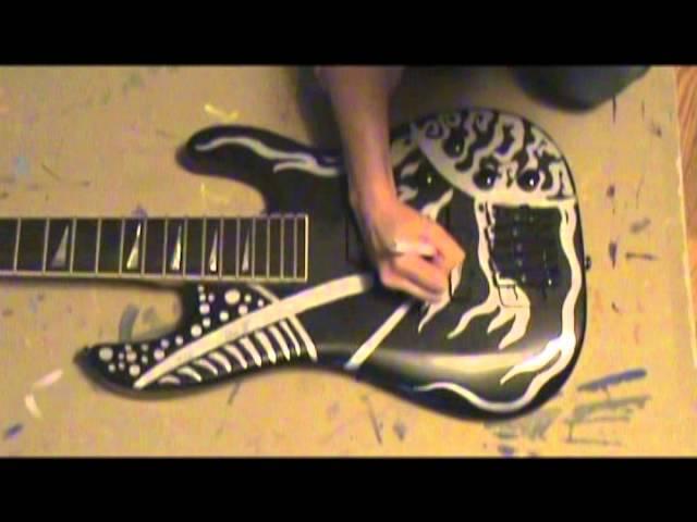 Emily Suzanne, painting a bass guitar