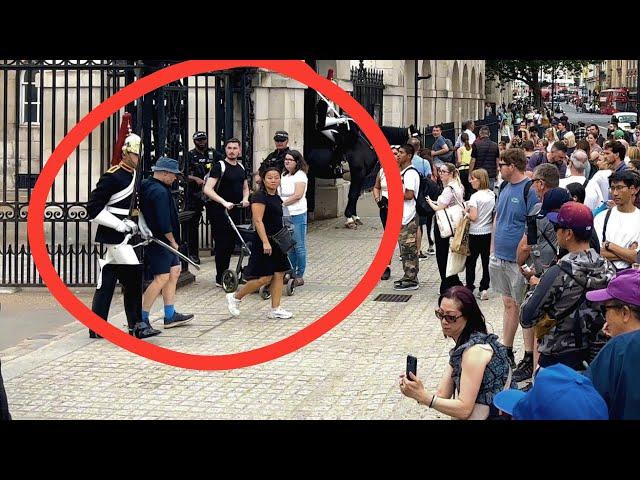 Watch Armed Officers Reaction As The King’s Guard Nudges A Man Out Of His Way