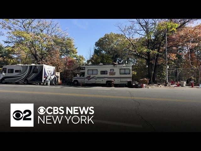 Bronx street lined with abandoned vehicles, RVs