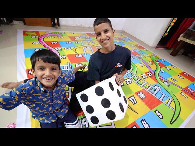 Playing Snakes & Ladder Game  With Brothers