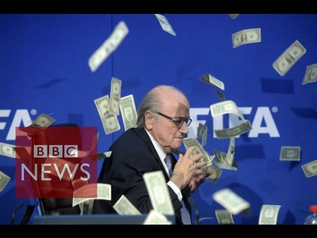 Moment Sepp Blatter was showered with fake dollar bills - BBC News