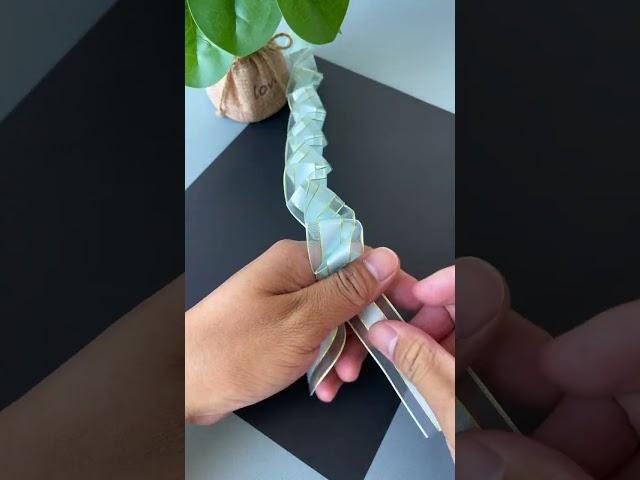 A ribbon is folded and pulled to become a beautiful rose flower. DIY handmade kindergarten handm