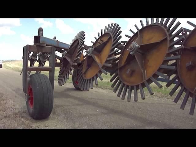 8 Pin Wheel Hydraulic Lift Stickrake (Rock Rake) towing on farm - Multi Farming Systems