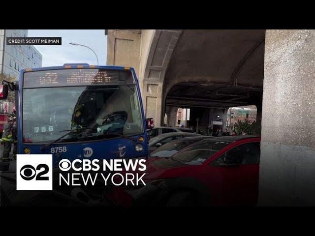 MTA bus crashes onto a sidewalk in Queens, injuring at least two passengers