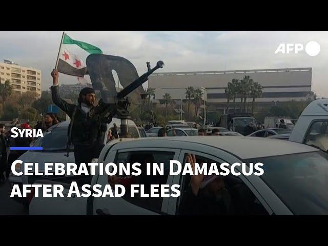 Syrians and fighters celebrate in Damascus | AFP