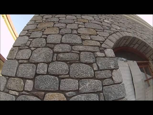 Building a house made of granite. Unique stone masonry