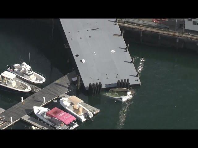 Massive pier crashes down when crane straps give way