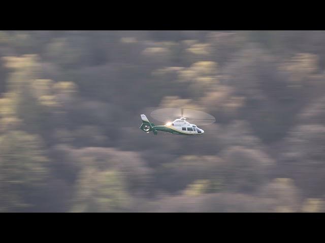 Great North Air ambulance flying low over Ullswater in the Lake District UK