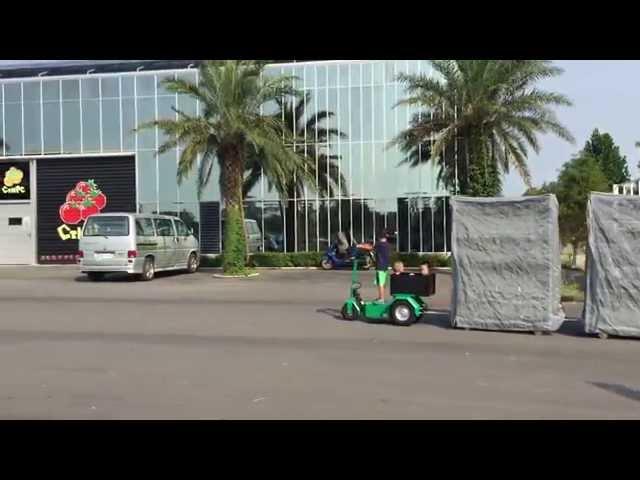 Electric Trike by little boy in Taiwan pulling cc containers