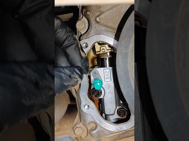 Pulling pin timing chain tensioner