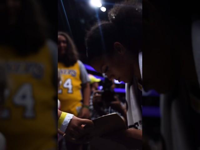 Rae Burrell signing for fans after the game