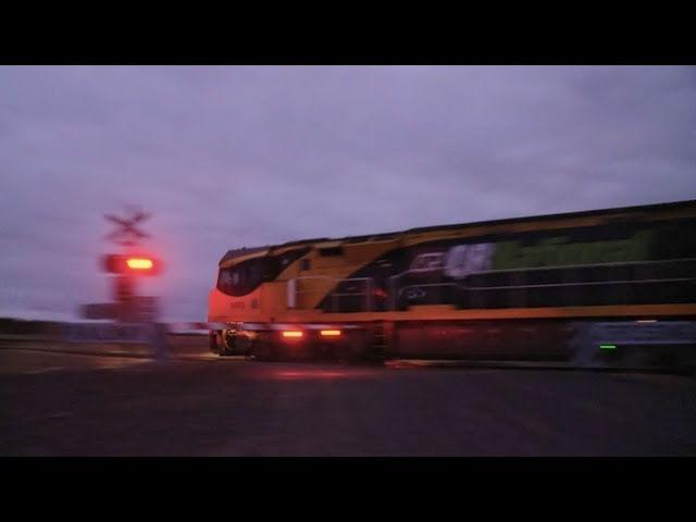 QRNational (Aurizon) Freight Train at Level Crossing (18/1/2011) - PoathTV Australian Railways