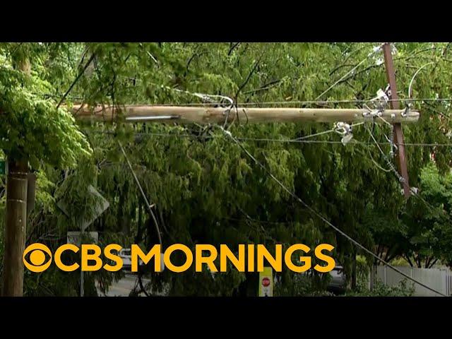 Storms knock out power across East Coast as heat wave builds