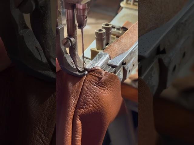 Stitching this leather bind around the top of this bag, in our Bondi Brach workshop.