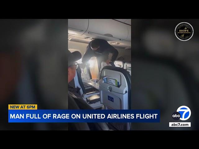 Passengers restrain unruly man kicking seat, smashing tray in violent outburst during flight | VIDEO