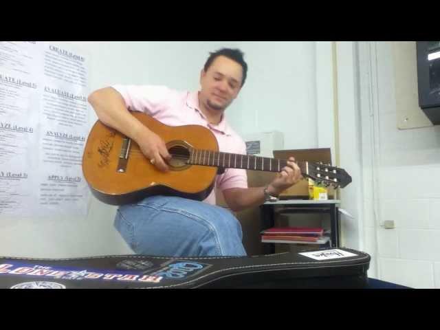 math teacher singing and playing guitar