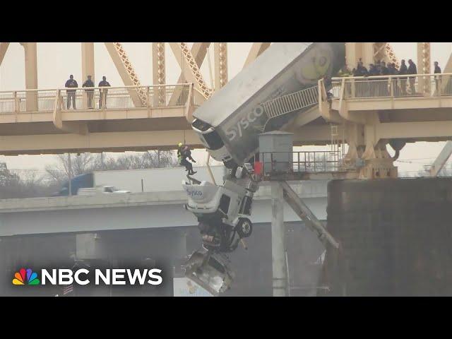 Louisville firefighters rescue driver from truck dangling off bridge