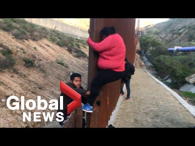 Migrant families continue to spill over Tijuana border fence, head to U.S.