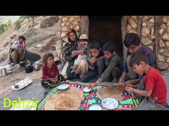 The father of the nomadic family cooking local bread for his children in the mountains