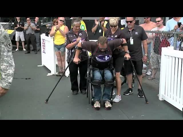 U.S. Army Pilot Gary Linfoot stands for National Anthem with Exoskeleton