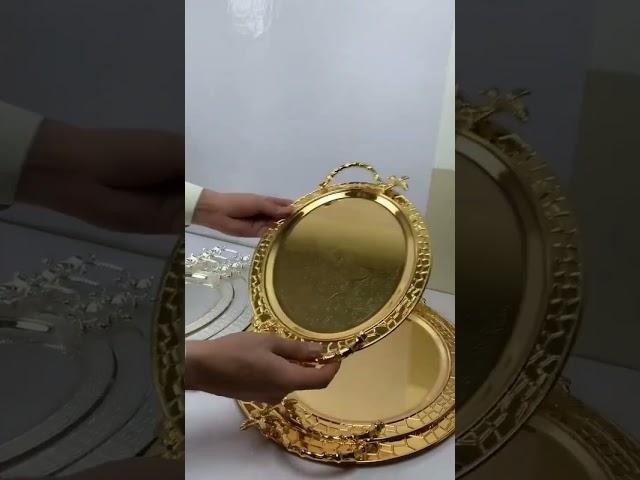 golden and sliver serving trays
