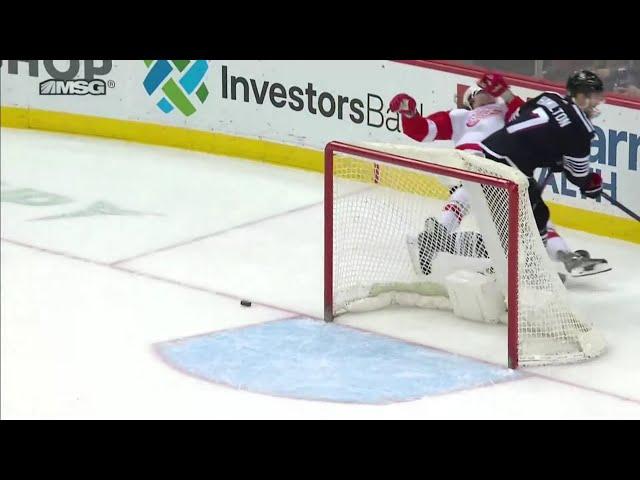 Dougie Hamilton hits Tyler Bertuzzi as he tries to shoot the puck into the empty net