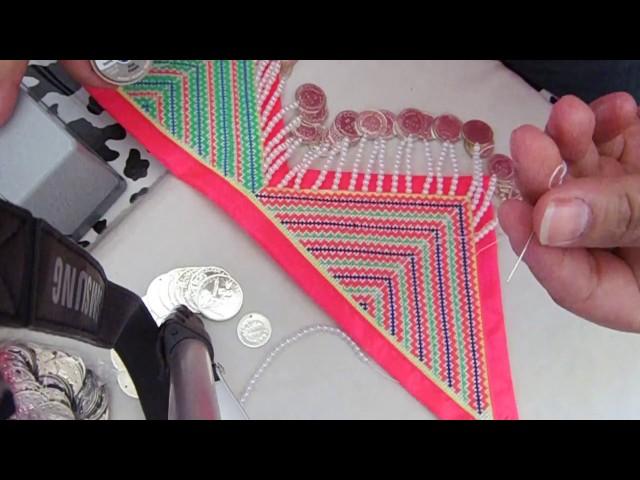 Adding coins to coin belt.