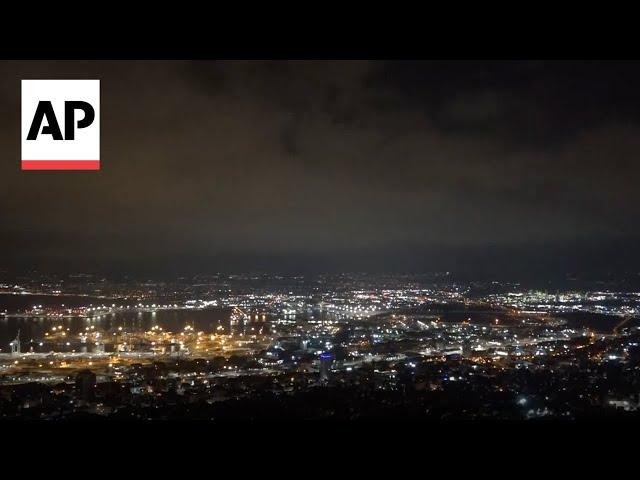 Security personnel clear rubble after sirens and blasts heard in Haifa